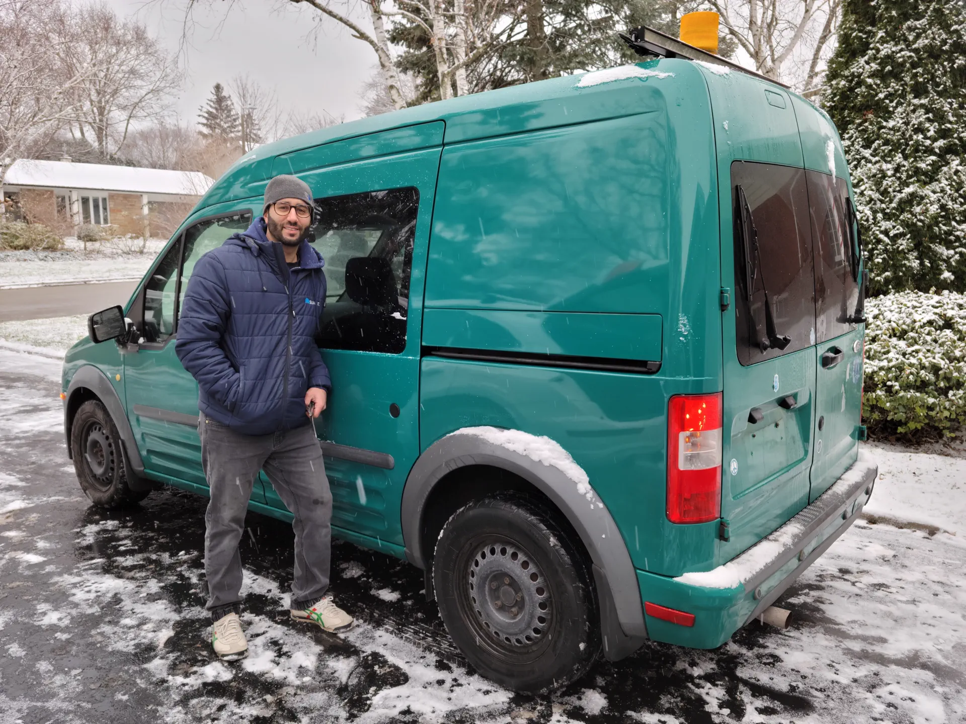 Towne Electric Inc. owner standing beside the company service van.