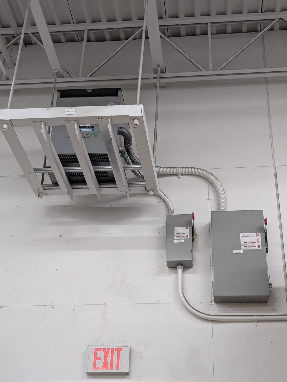 Commercial conduit, exit lighting, and wall-mounted electrical systems.