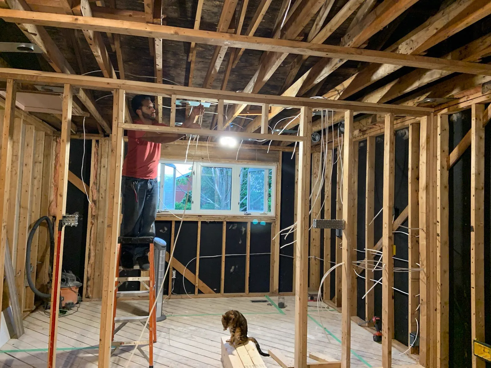 Residential renovation framing with electrical rough-in wiring, wall boxes, and lighting prep.